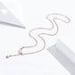 Rose-gold plated moon-and-star pendant necklace laid out on a surface