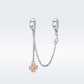 Platinum-plated safety chain bracelet with gold-tone clover charm and loops