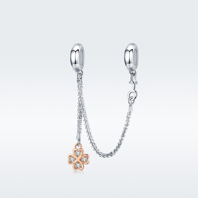 Platinum-plated safety chain bracelet with gold-tone clover charm and loops