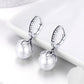 Small silver hoop earrings with CZ ring trim and pearl drop