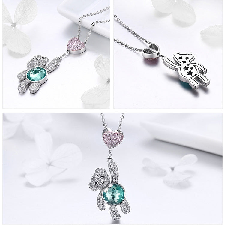 Double-charm necklace: pink heart CZ pendant and silver bear with teal crystal