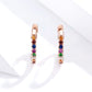 Rose gold mini hoop earrings with multicolor zircon stones, close-up