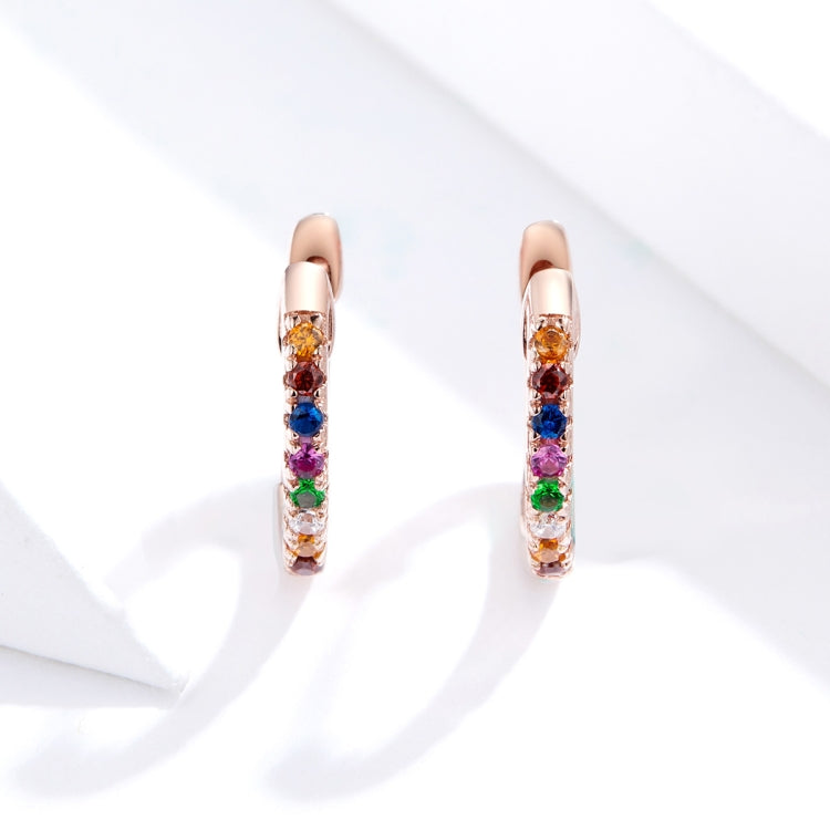 Rose gold mini hoop earrings with multicolor zircon stones, close-up