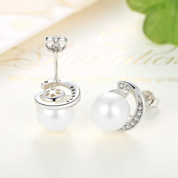 White pearl stud earrings showing silver back post and round stone halo