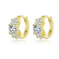 Gold-tone CZ hoop earrings with round center stone and pave cluster stones
