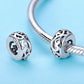 Pair of heart-shaped S925 silver charm beads with curly grass love pattern on bracelet