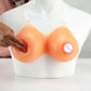 Silicone prosthetic breasts with clear straps on mannequin bust, hand adjusting