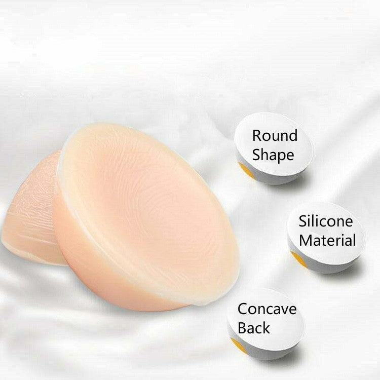 Round silicone breast inserts showing textured front and concave back surfaces