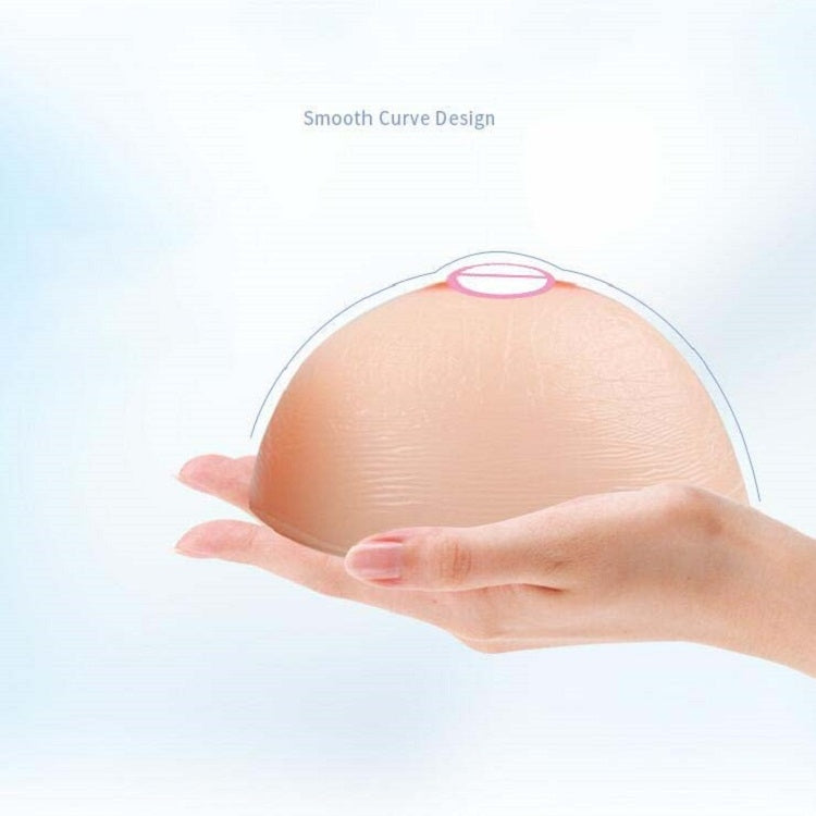 Round silicone breast insert with smooth curve and artificial nipple areola detail