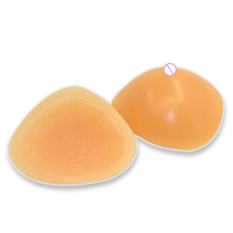 Triangular concave silicone breast prostheses, smooth tan, two pieces shown