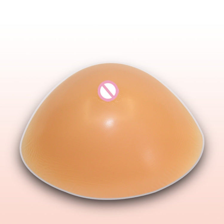 Smooth tan triangular silicone breast insert with concave underside