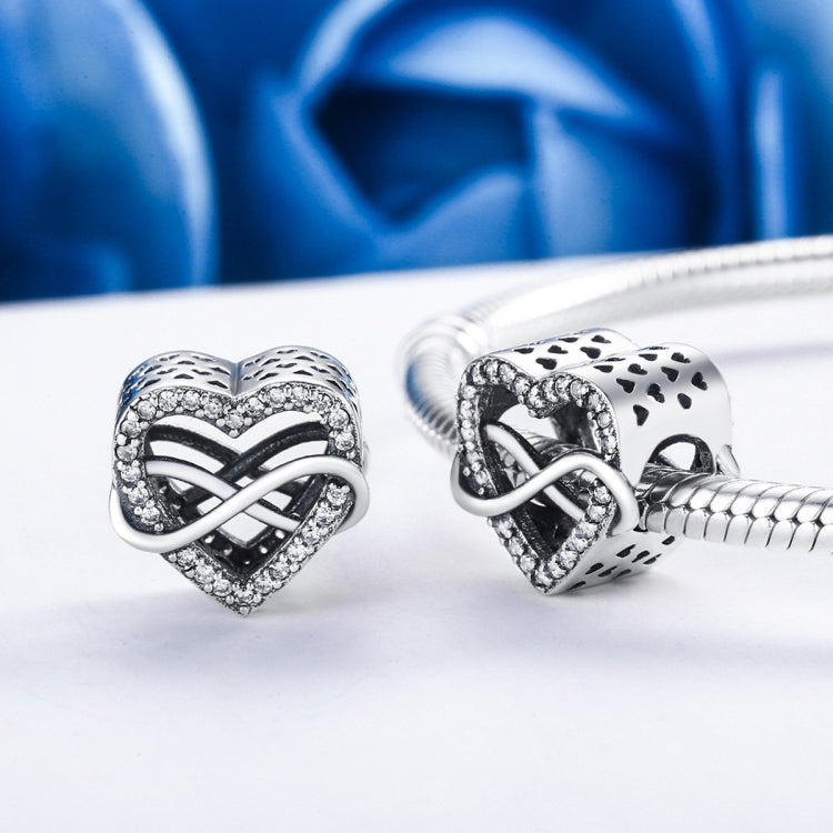 Sterling silver heart-shaped hollow bead charms on a bracelet chain