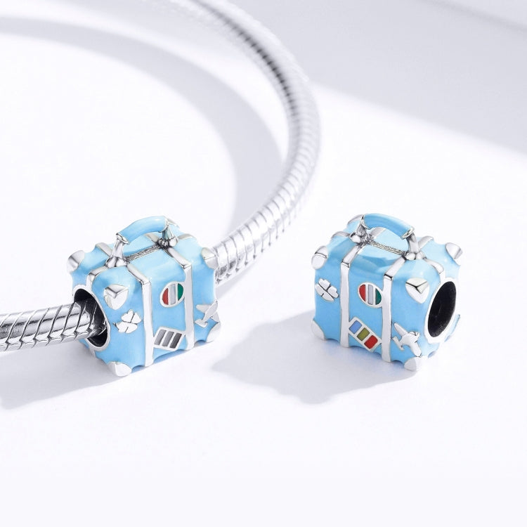 Blue suitcase charm bead on a silver charm bracelet with a second charm