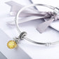 Silver bracelet charm with faceted yellow pineapple bead and textured pineapple cap