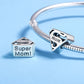 Sterling silver bracelet charm with 'mom' cube bead and heart cutouts