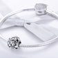 Sterling silver flower charm bead on a snake-chain bracelet with tassel accent