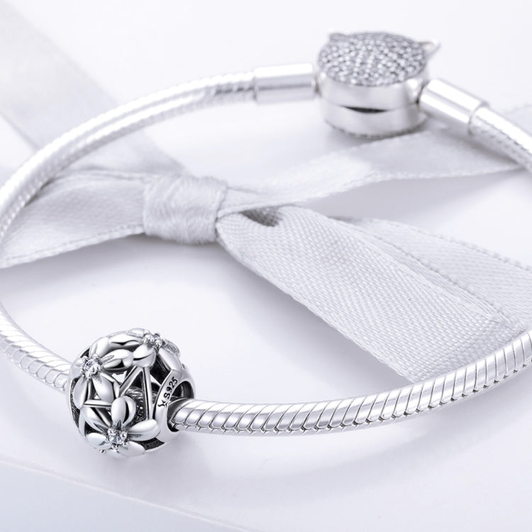 Sterling silver flower charm bead on a snake-chain bracelet with tassel accent