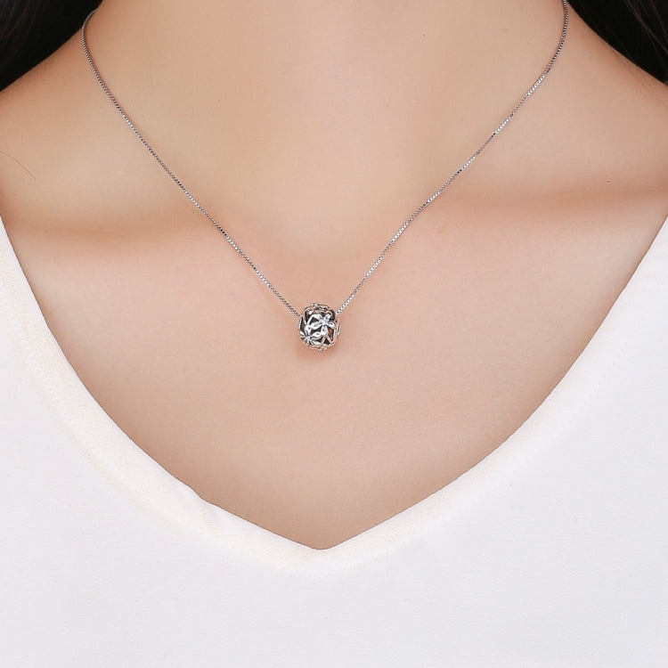 Round CZ pendant necklace with a silver-tone chain and small clear center stone