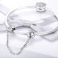 Sterling silver safety chain attached to a charm bracelet with two bead clips
