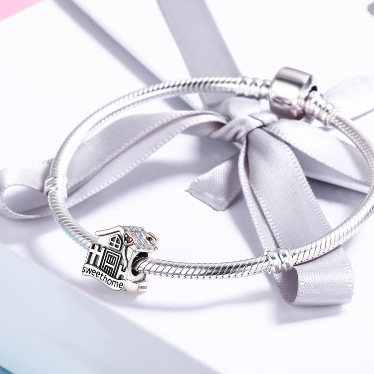 Sterling silver charm bracelet with house charm bead and white ribbon