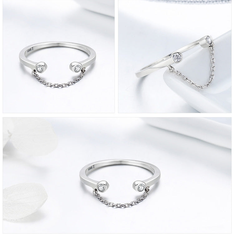 Silver open ring with two round CZ stones and a linked chain detail on the band