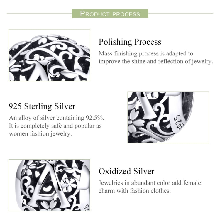 Sterling silver letter bead with black-and-silver floral scrollwork, close-up detail