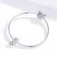 Silver charm bracelet with daisy bead, teal glass drop, and round sparkle end charm