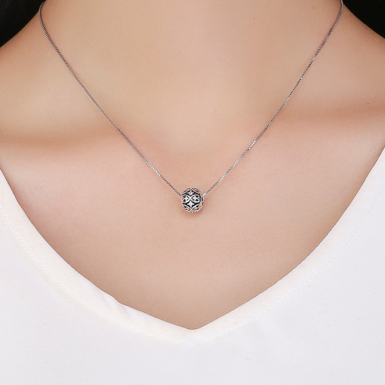 Sterling silver round pendant with black enamel pattern and crystal center on chain