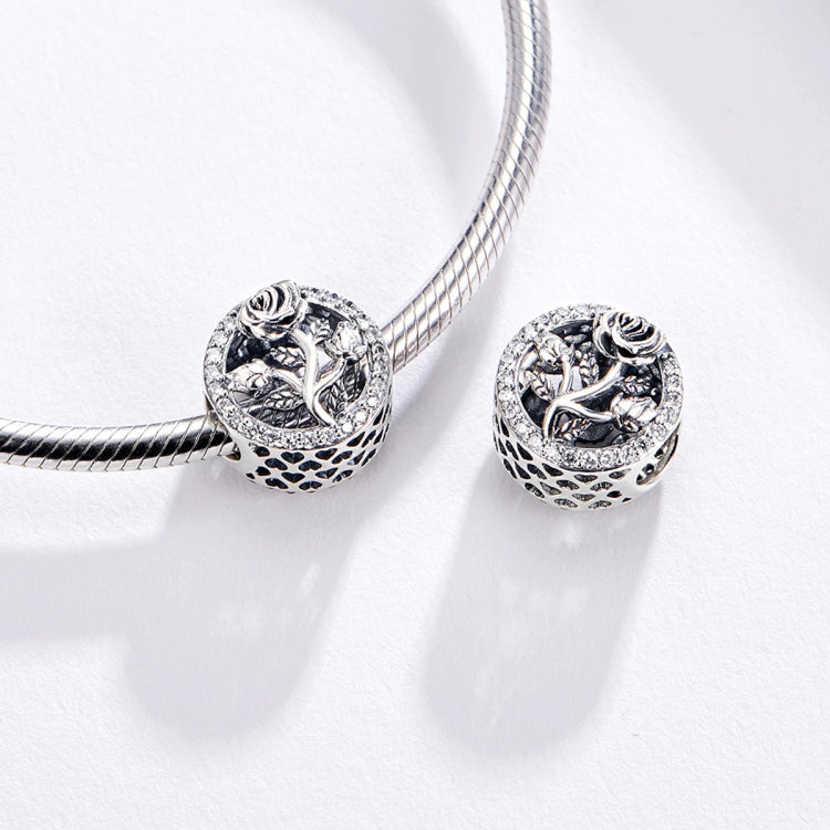 Oxidized silver rose charm beads on a linked bracelet strand