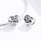 Two silver heart paw print bead charms on a snake chain bracelet