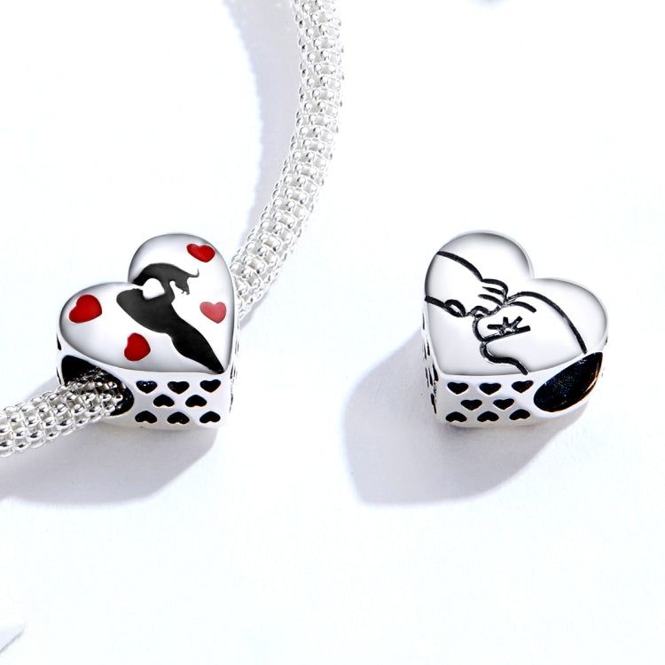Sterling silver bracelet with two heart-shaped charms in black silhouette and red enamel