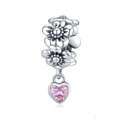 Oxidized silver flower charm bead with pink heart-shaped gemstone drop