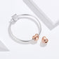 Silver snake bracelet with a top silver CZ heart charm and a rose gold heart bead charm