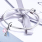 Silver beaded bracelet with pink paw-print enamel charm and CZ accents, tied ribbon
