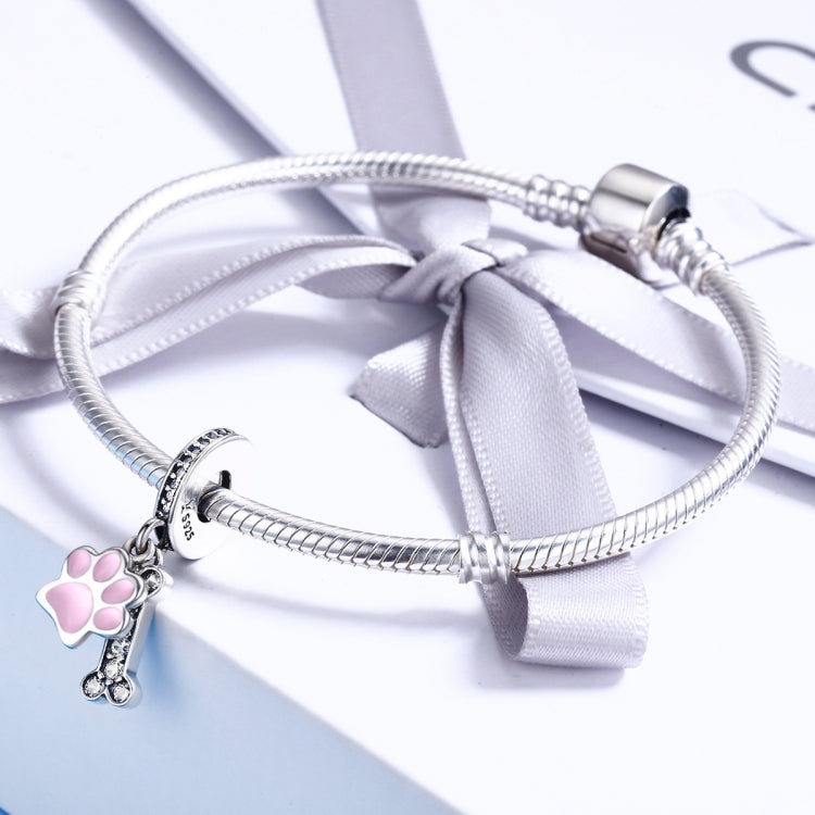 Silver beaded bracelet with pink paw-print enamel charm and CZ accents, tied ribbon