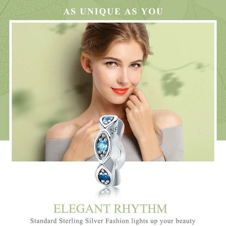 Sterling silver eye charm bead with blue crystal centers in oval settings