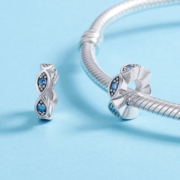 Sterling silver eye bead charm with blue stones on a bracelet