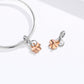 Silver bracelet with two clover charms: rose-gold petals, heart centers, CZ accents