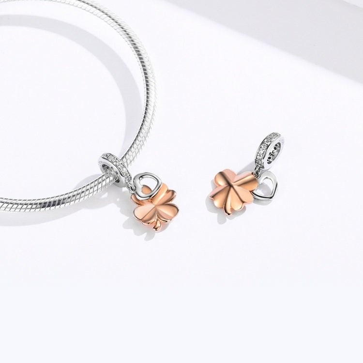 Silver bracelet with two clover charms: rose-gold petals, heart centers, CZ accents