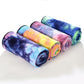 Stack of folded microfiber non-slip yoga mat towels in multi-color rainbow tie-dye