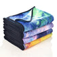 Folded microfiber non-slip yoga mat towels stacked in blue, purple, green, and yellow