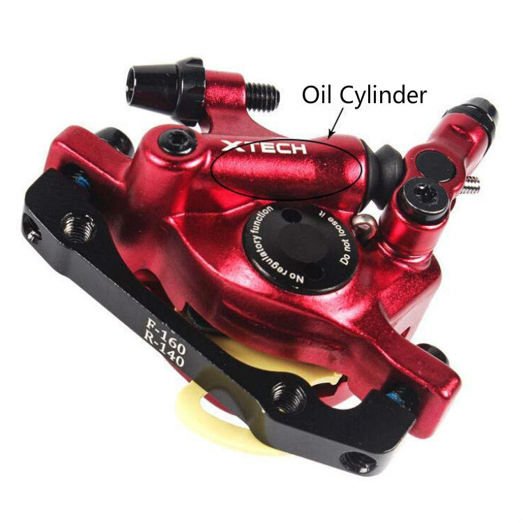 Red hydraulic disc brake caliper with oil port and mounting bolts, close-up view