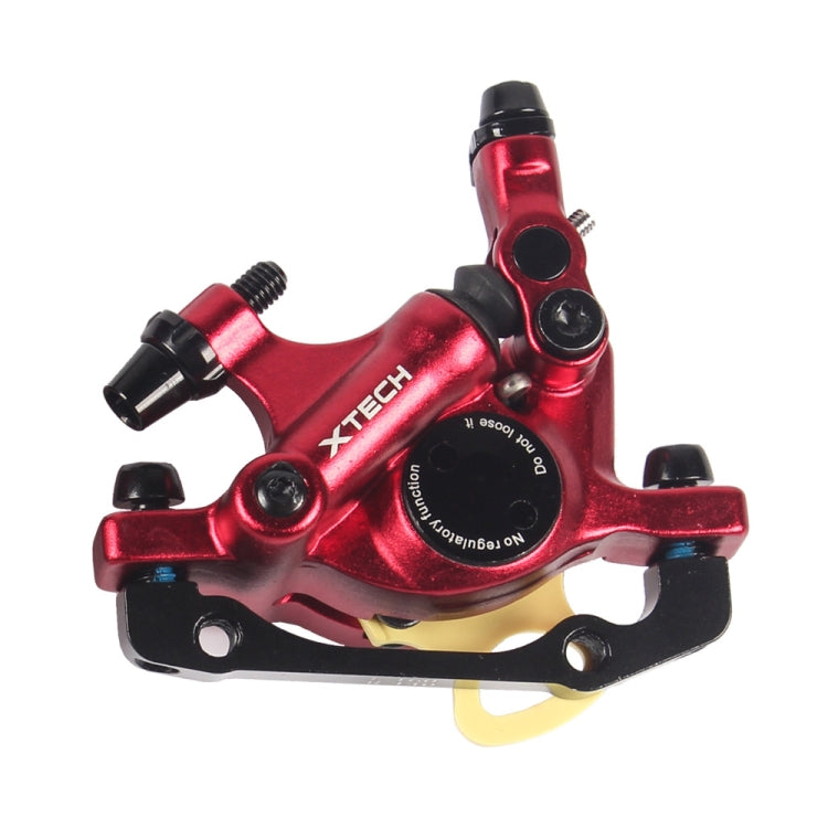 Red hydraulic disc brake caliper with mounting bracket and hose port