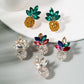 Colorful rhinestone pineapple stud earrings with green, gold, and blue accents
