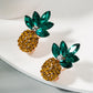 Yellow rhinestone pineapple stud earrings with emerald-green crystal leaves