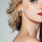Pineapple rhinestone stud earrings with green leaves and gold sparkle on model