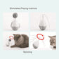 White electric cat egg toy with spinning feather design and fuzzy pom‑pom heads