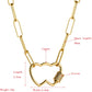 Gold-tone double heart pendant necklace with bezel-set multicolor zircon on the clasp