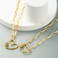 Gold-tone double heart pendant necklace with multicolor zircon accents on curved charms