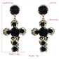 Pair of black rose cross long dangle earrings with rhinestones and gold-tone details